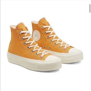 Mustard yellow high top platform converse.